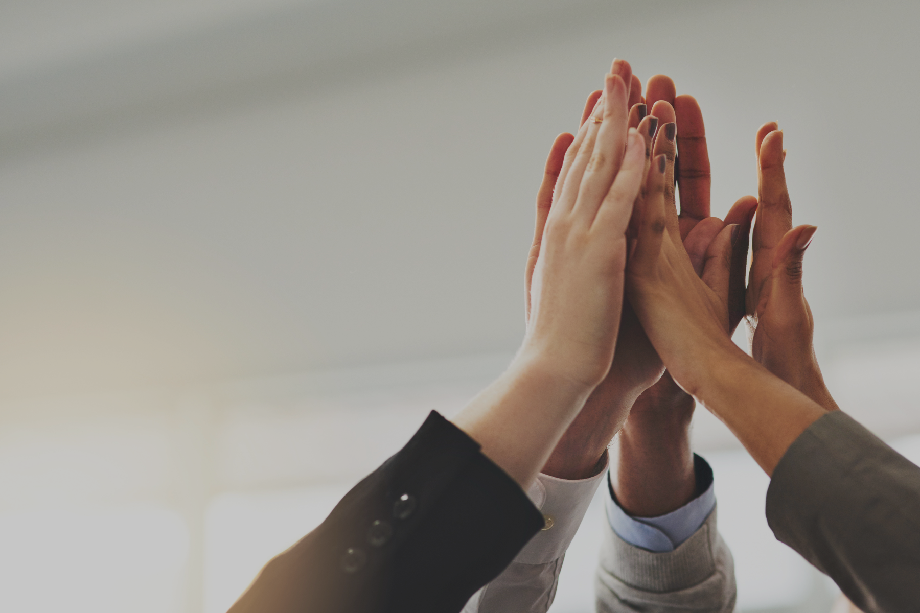 Temporary Customer Success Hiring - image of temporary customer success team high fiving after successful meeting