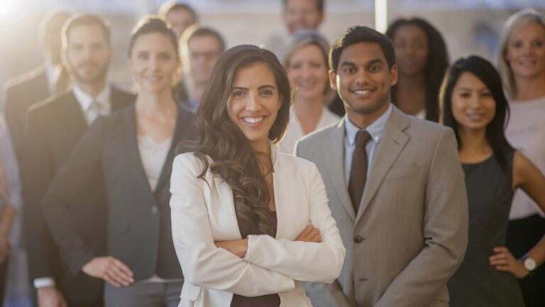 Group of professionals standing together at an on-demand staffing agency, AccountMakers.