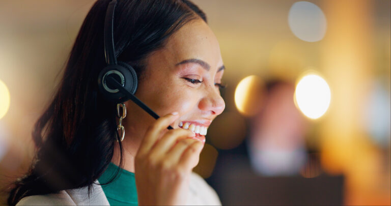 temporary sales staffing women is seen smiling and closing a sale on the phone after a sales training tip
